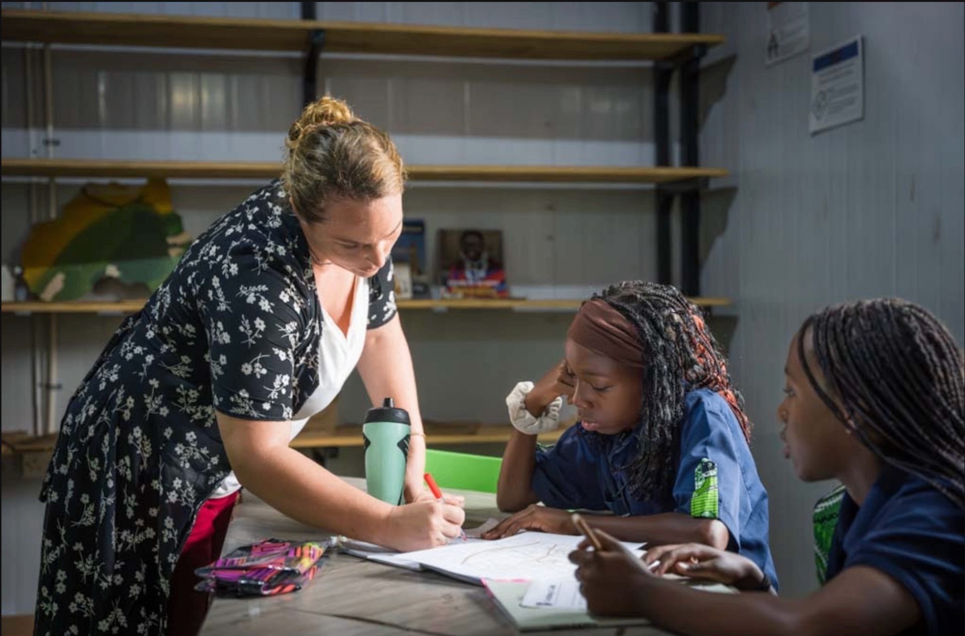 A 7Hills teacher helping students during a lesson